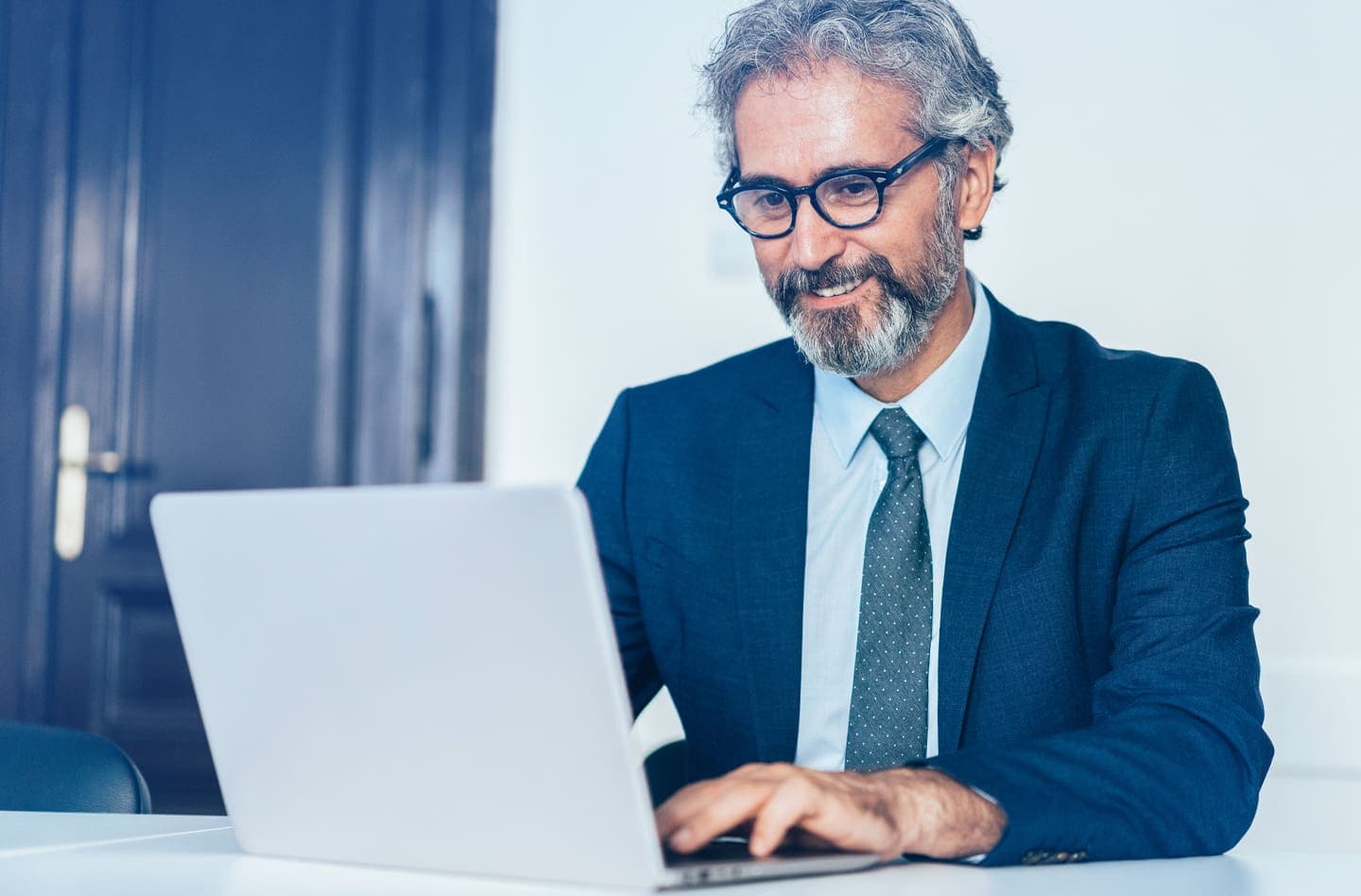 man with glasses using a laptop
